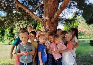 Dzieci przytulające się do drzewa