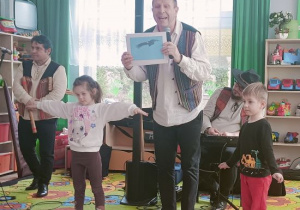 Pan z Filharmonii z Niną i Daniilem pokazuje zdjęcie ptaka Kondora Wielkiego