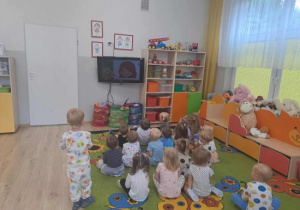 Dzieci oglądają film edukacyjny o kropce.