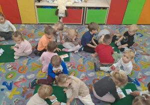 Dzieci układają puzzle z pieskami.