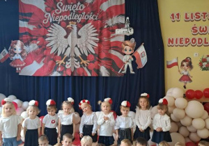 Dzieci z grupy Motylków na tle dekoracji z okazji Święta Niepodległości